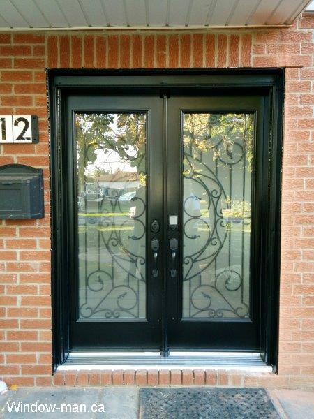 Double front entry steel insulated exterior doors. Black. Rochester traditional wrought iron glass inserts. Professionally installed